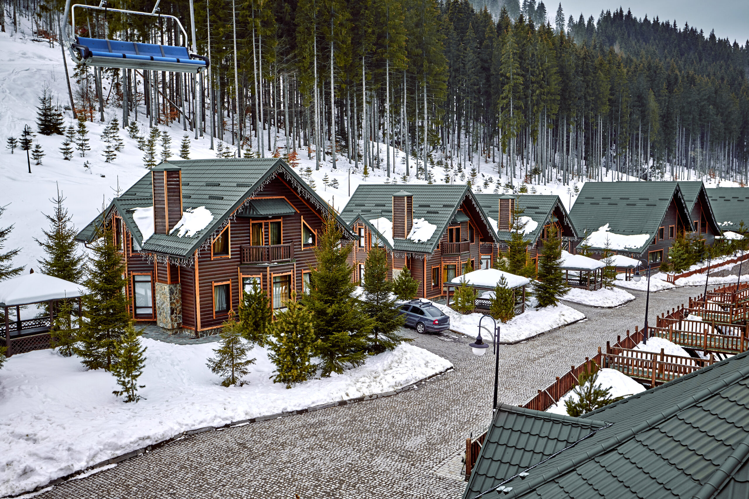 Winter vacation holiday wooden house in the mountains covered with snow and blue sky.